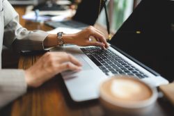 Someone typing on a laptop